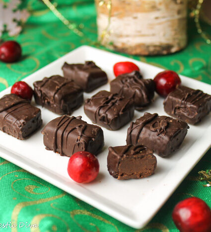 a square white plate filled with rectangle shaped homemade truffles